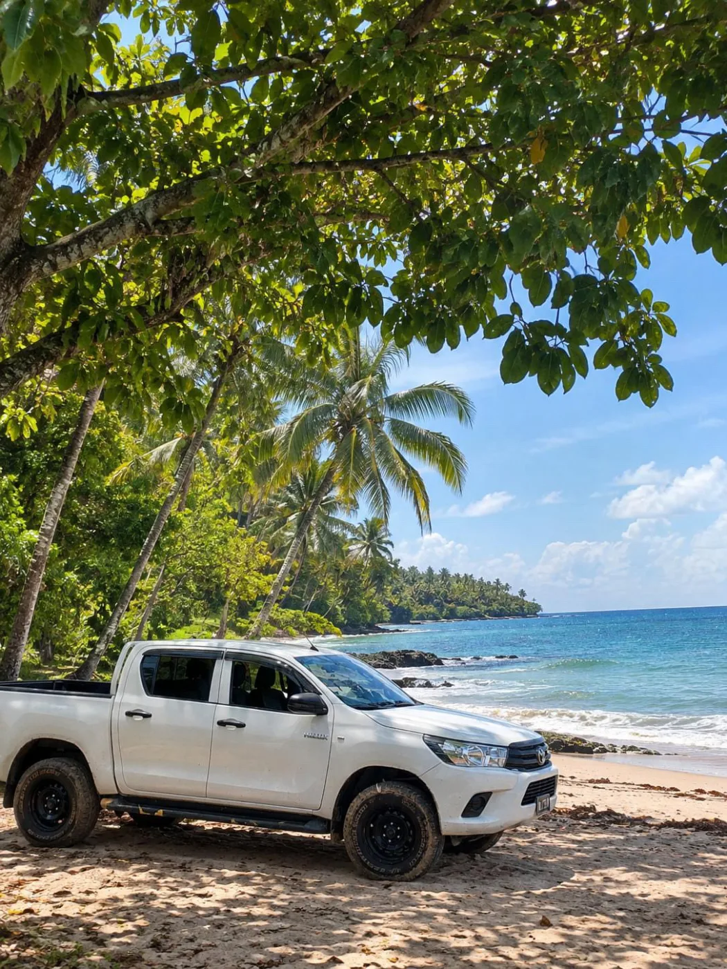 Toyota Hilux rental beside a tropical beach in Espiritu Santo
